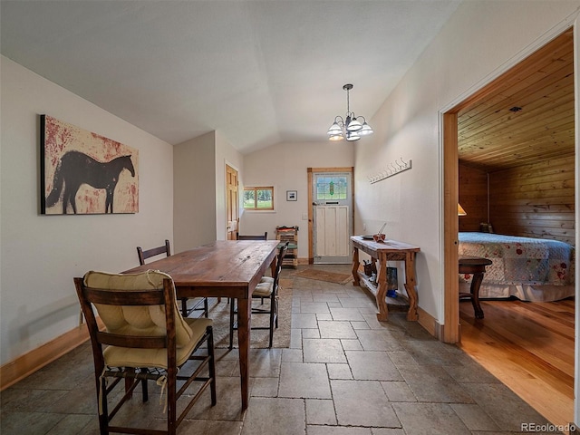 29548 Sunset Trl, Pine, CO 80470 - dining room with a chandelier, stone tile flooring, lofted ceiling, and baseboards