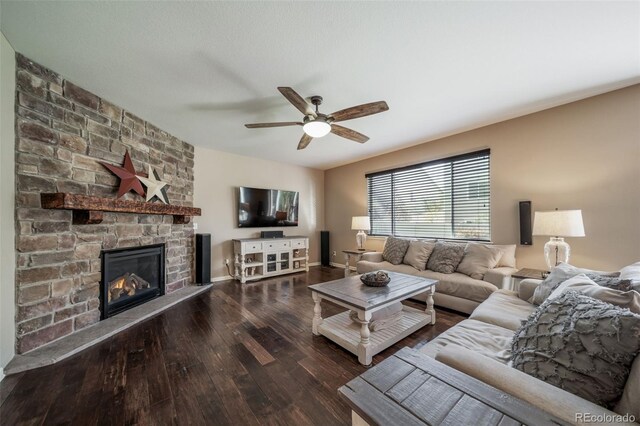 living room with ceiling fan, dark hardwood / wood-style flooring, and a fireplace