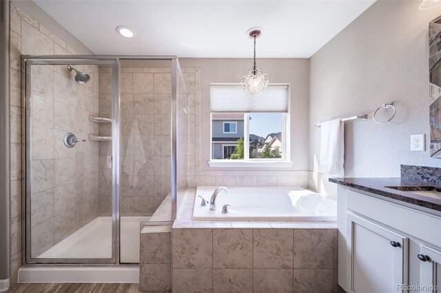 bathroom with vanity and independent shower and bath