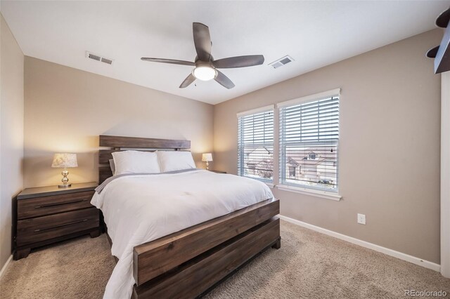 bedroom with ceiling fan and light colored carpet