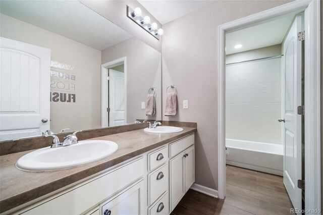 bathroom with vanity and washtub / shower combination