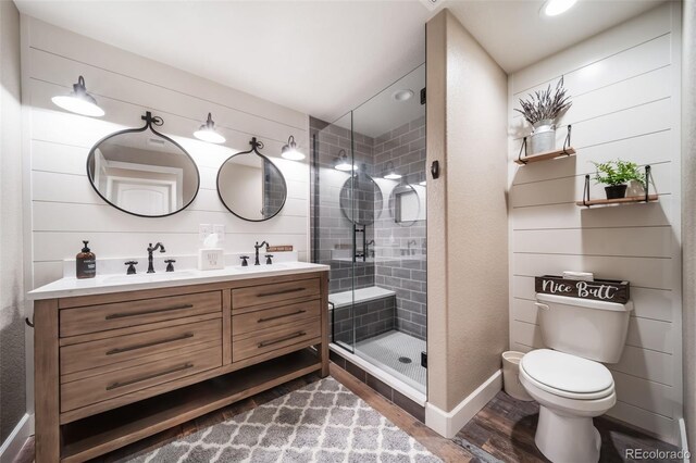 bathroom with wood-type flooring, toilet, walk in shower, and vanity