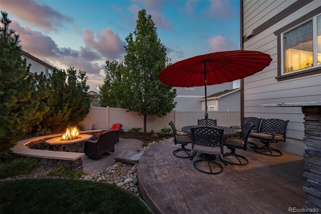 patio terrace at dusk with an outdoor fire pit