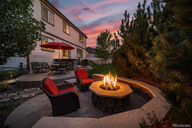 patio terrace at dusk with a fire pit