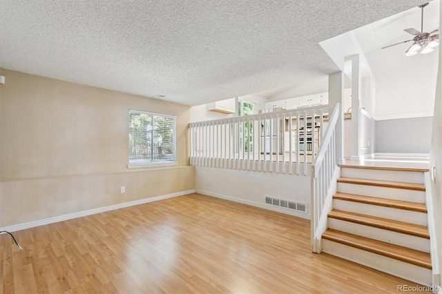4947 S Espana Way, Centennial, CO 80015 - unfurnished room with a textured ceiling, wood finished floors, stairs, and ceiling fan