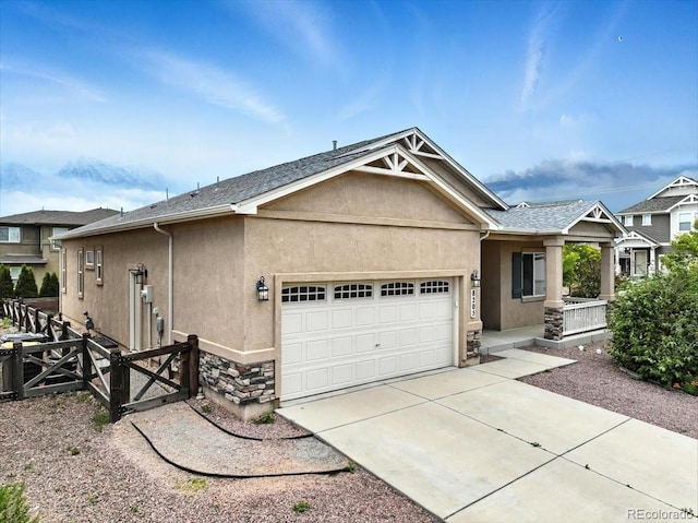 8205 Birch Tree Loop, Colorado Springs, CO 80927 - view of front facade with an attached garage, stucco siding, stone siding, and concrete driveway
