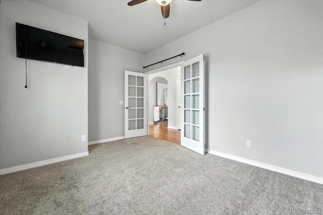 8205 Birch Tree Loop, Colorado Springs, CO 80927 - spare room with french doors, carpet flooring, arched walkways, and a ceiling fan