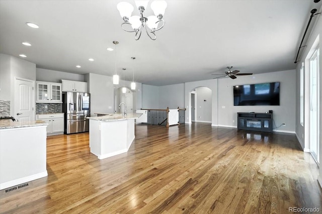 8205 Birch Tree Loop, Colorado Springs, CO 80927 - kitchen with stainless steel fridge, arched walkways, ceiling fan, light wood-type flooring, and recessed lighting