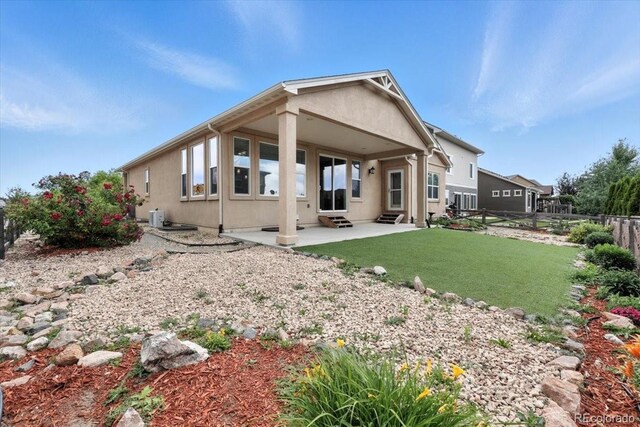 8205 Birch Tree Loop, Colorado Springs, CO 80927 - back of property featuring entry steps, a fenced backyard, stucco siding, and a patio area