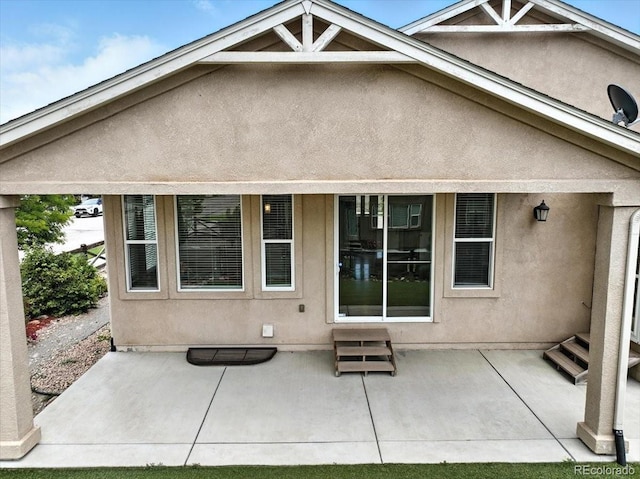 8205 Birch Tree Loop, Colorado Springs, CO 80927 - rear view of house with a patio, entry steps, and stucco siding