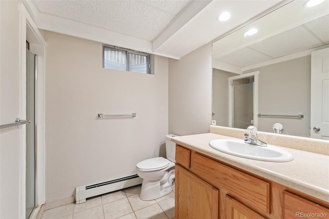 bathroom featuring a baseboard heating unit, vanity, toilet, and tile patterned flooring