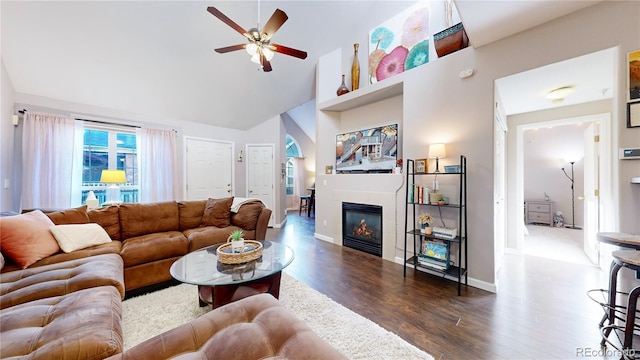 living room with dark wood-type flooring, high vaulted ceiling, and ceiling fan