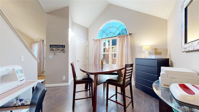 dining space with high vaulted ceiling and dark hardwood / wood-style floors