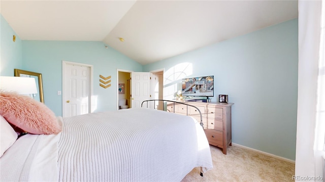 carpeted bedroom with lofted ceiling