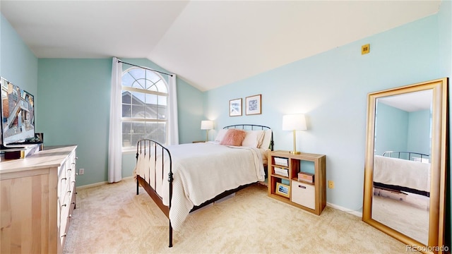 carpeted bedroom with vaulted ceiling