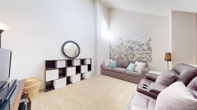 carpeted living room featuring high vaulted ceiling