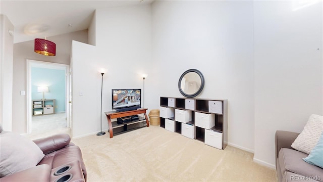 living room with high vaulted ceiling and light carpet