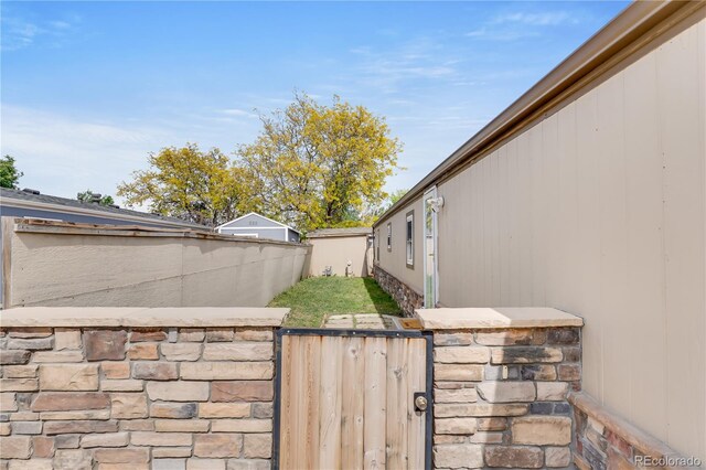 8426 Cook Way, Denver, CO 80229 - exterior view of stone siding and a gate