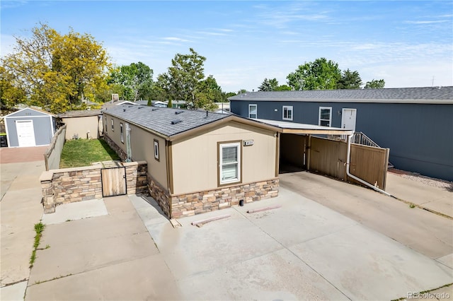 8426 Cook Way, Denver, CO 80229 - view of front of home with a gate, stone siding, and concrete driveway