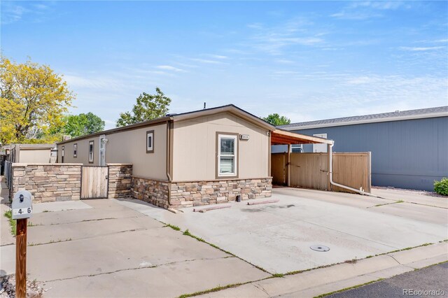 8426 Cook Way, Denver, CO 80229 - view of front of home featuring stone siding and a gate