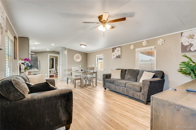 8426 Cook Way, Denver, CO 80229 - living room with a ceiling fan, light wood finished floors, vaulted ceiling, and crown molding