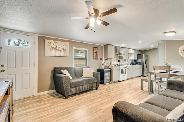 8426 Cook Way, Denver, CO 80229 - living area with a ceiling fan, light wood-style floors, crown molding, recessed lighting, and baseboards
