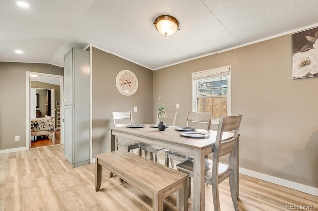 8426 Cook Way, Denver, CO 80229 - dining space featuring ornamental molding, light wood finished floors, baseboards, and lofted ceiling