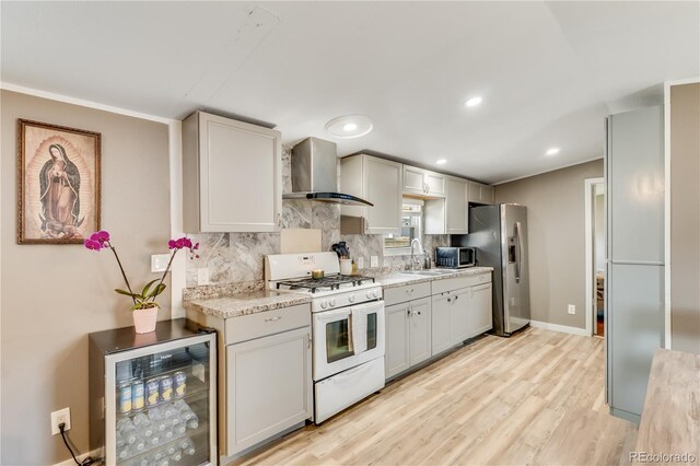 8426 Cook Way, Denver, CO 80229 - kitchen featuring appliances with stainless steel finishes, wall chimney range hood, wine cooler, decorative backsplash, and recessed lighting