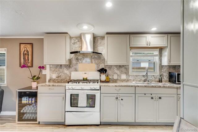 8426 Cook Way, Denver, CO 80229 - kitchen with wall chimney range hood, white range with gas stovetop, wine cooler, a sink, and backsplash