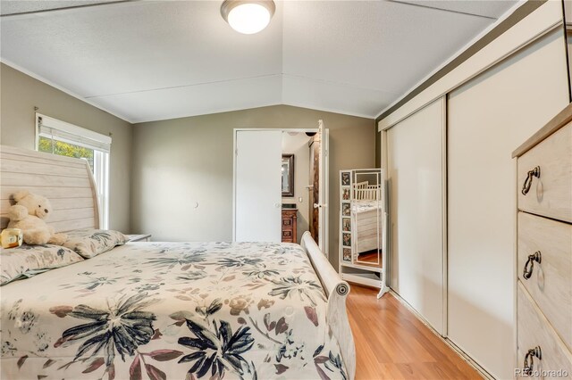 8426 Cook Way, Denver, CO 80229 - bedroom featuring vaulted ceiling, light wood-style flooring, and a closet
