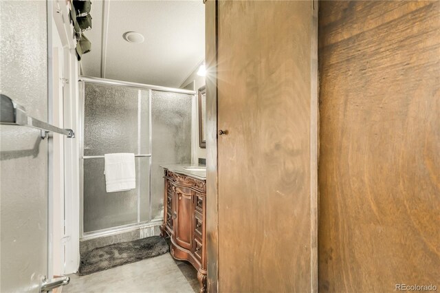 8426 Cook Way, Denver, CO 80229 - bathroom with a shower stall, vanity, and concrete floors
