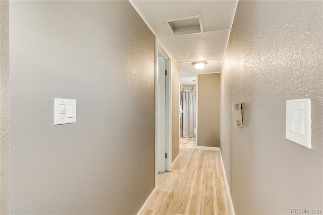 8426 Cook Way, Denver, CO 80229 - hallway with light wood-style flooring, attic access, and baseboards