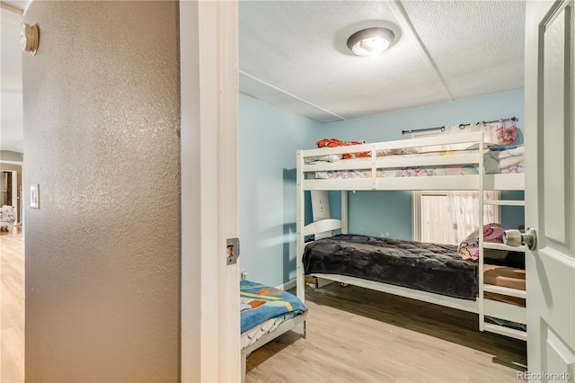 8426 Cook Way, Denver, CO 80229 - bedroom featuring wood finished floors and a textured ceiling