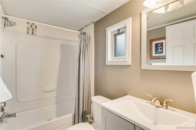 8426 Cook Way, Denver, CO 80229 - full bathroom featuring vanity, shower / tub combo, toilet, and a textured wall