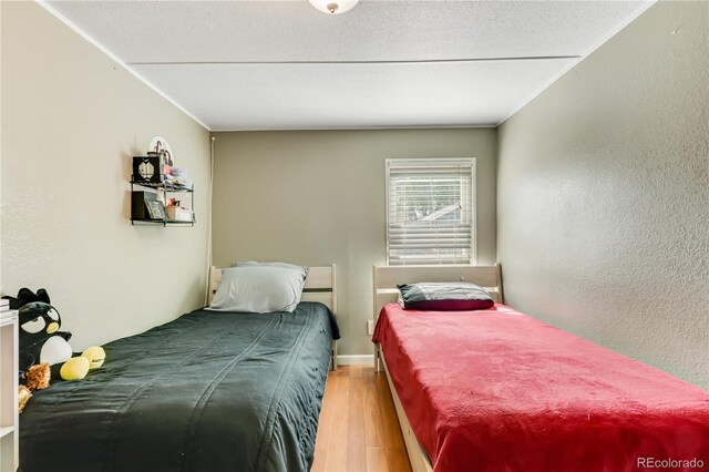 8426 Cook Way, Denver, CO 80229 - bedroom with wood finished floors and a textured wall