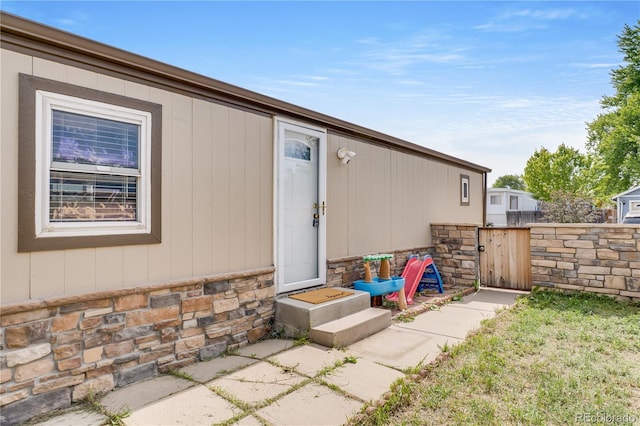 8426 Cook Way, Denver, CO 80229 - property entrance featuring stone siding and a gate