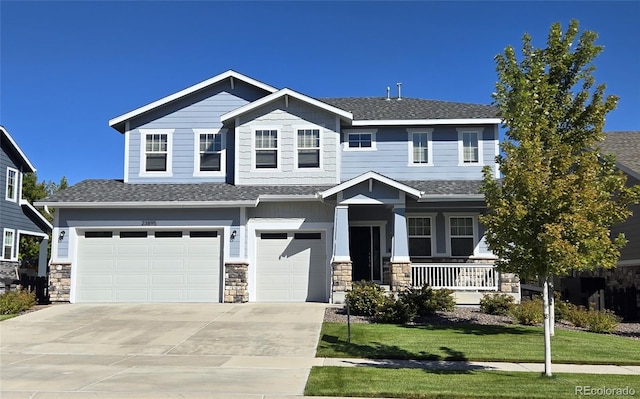 craftsman-style home featuring a garage and a front lawn