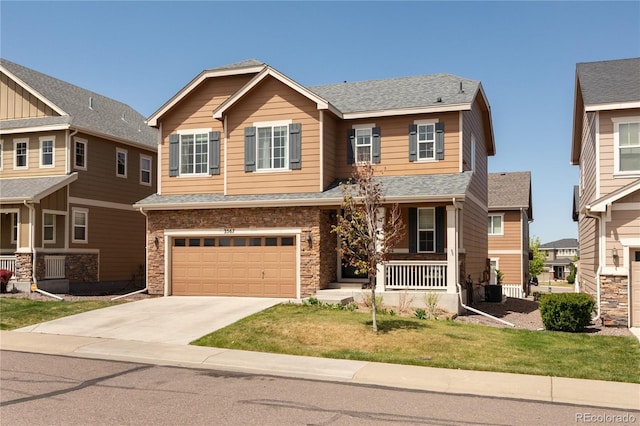 craftsman house with a front lawn, covered porch, a shingled roof, an attached garage, and driveway