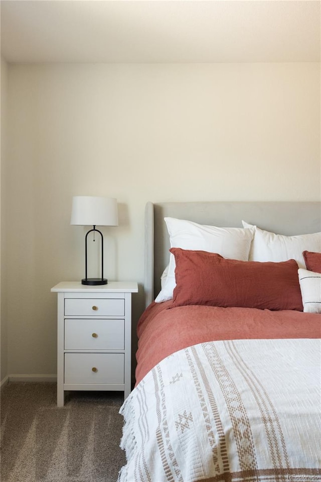 bedroom featuring baseboards and dark colored carpet