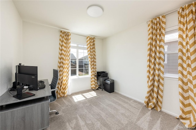 carpeted office space with baseboards