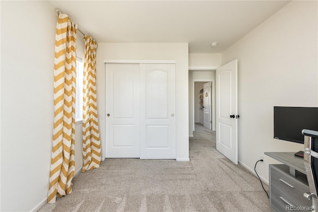 interior space with carpet flooring and baseboards
