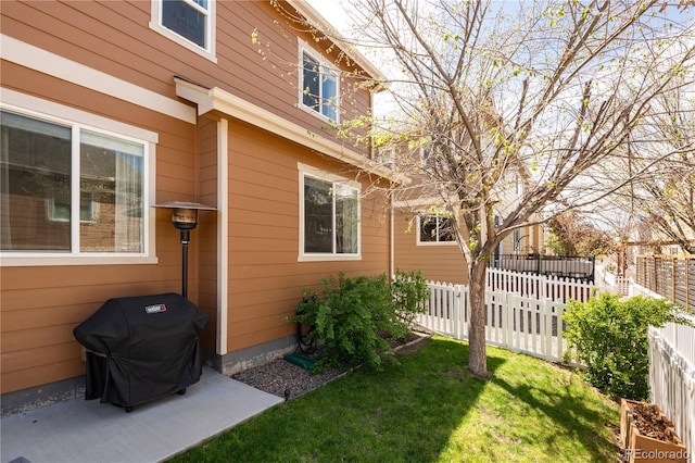 view of property exterior with fence and a yard
