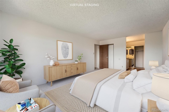 bedroom with a textured ceiling and light colored carpet