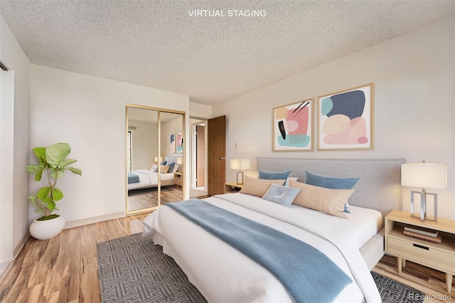 bedroom featuring wood finished floors, a closet, and a textured ceiling