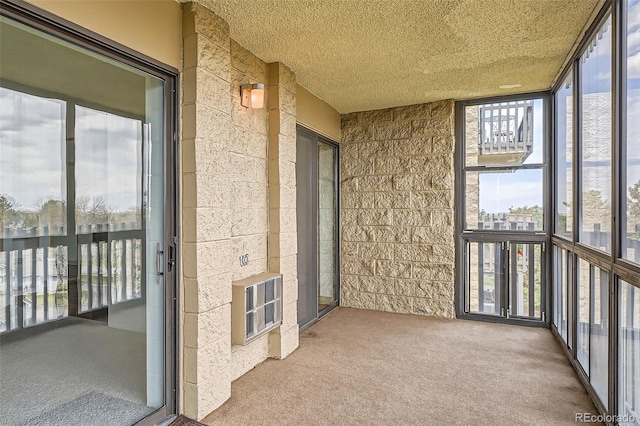 unfurnished sunroom with heating unit