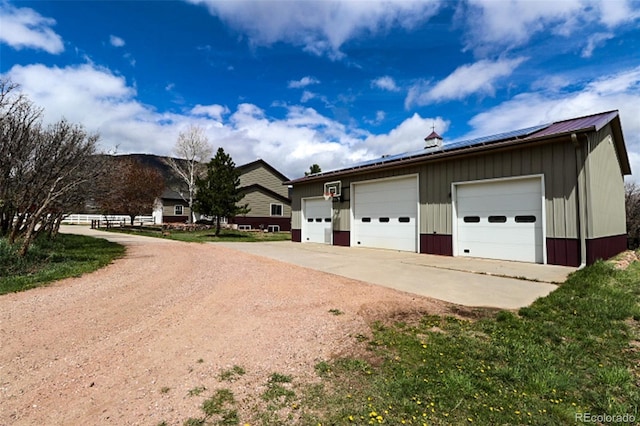 3530 Doolittle Rd, Monument, CO 80132 - view of side of property featuring a garage, board and batten siding, an outdoor structure, and metal roof