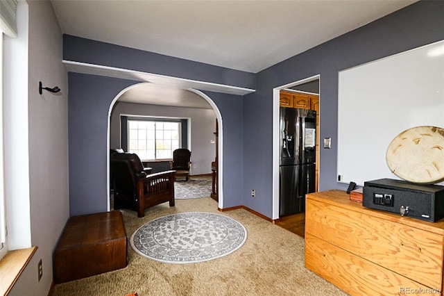 3530 Doolittle Rd, Monument, CO 80132 - sitting room featuring arched walkways, carpet flooring, and baseboards