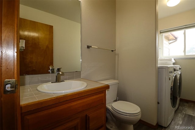 3530 Doolittle Rd, Monument, CO 80132 - half bath featuring wood finished floors, vanity, toilet, and independent washer and dryer