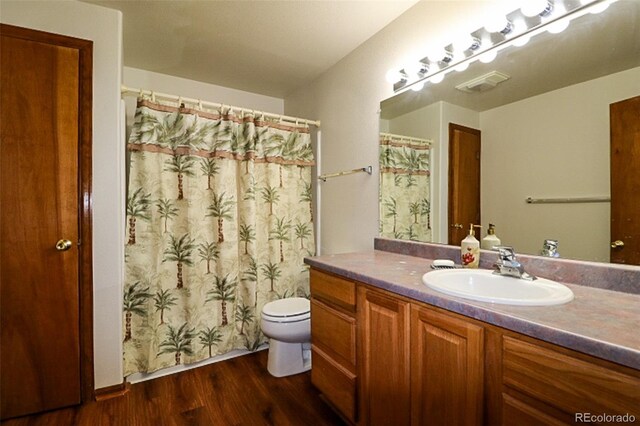 3530 Doolittle Rd, Monument, CO 80132 - full bathroom featuring vanity, wood finished floors, toilet, and a shower with curtain