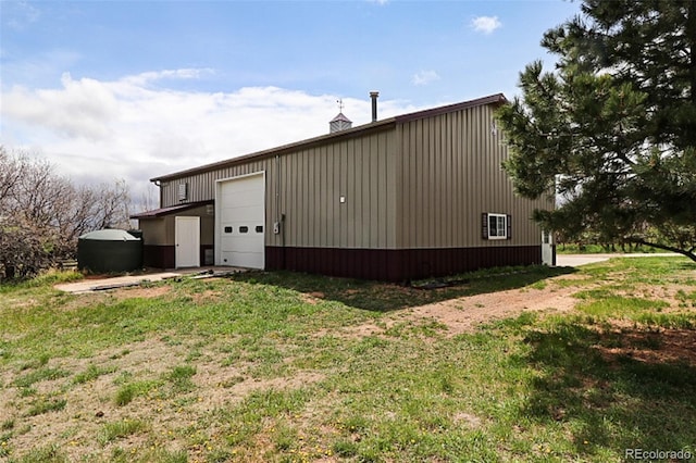 3530 Doolittle Rd, Monument, CO 80132 - view of property exterior featuring an outdoor structure, a garage, and a lawn